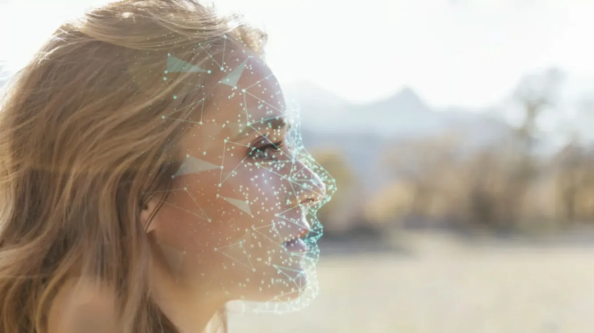 Woman’s profile with digital facial recognition network overlay.
